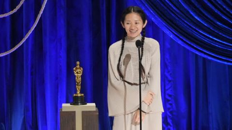 Chloe Zhao giving her Oscar acceptance speech onstage.